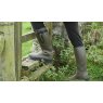 Man climbing stile in wellies