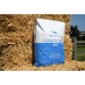 Bag of Conditioning Mix against a hay bale